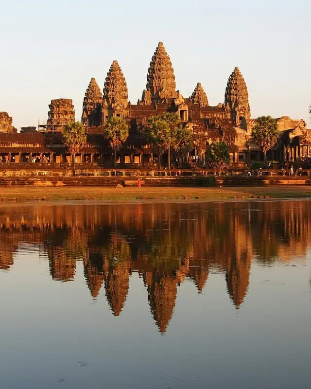 Angkor Wat's towers reflected in the pond in front of the temple at sunset